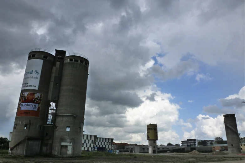 a concrete tower with two identical buildings behind it