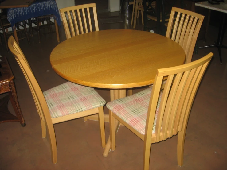 a dinette room table and chairs with an off - white checkered tablecloth