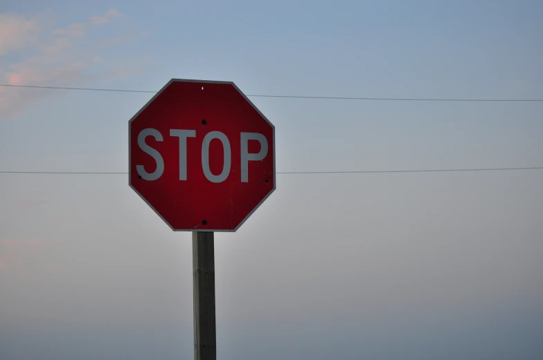 a stop sign that is in front of a power line