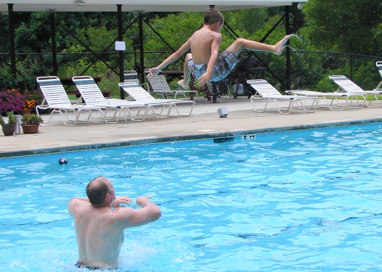 there are two men that are standing in the water