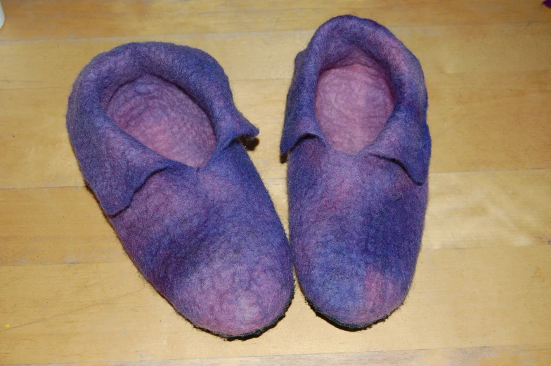 purple slippers lying on the floor on a table