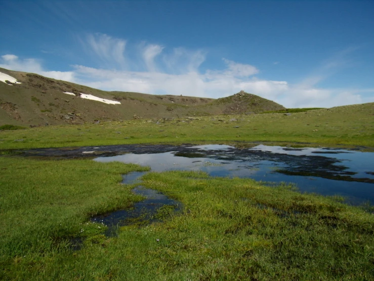 the water has running through it at the foot of the hills