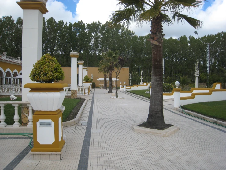 a brick walk way surrounded by lush green trees