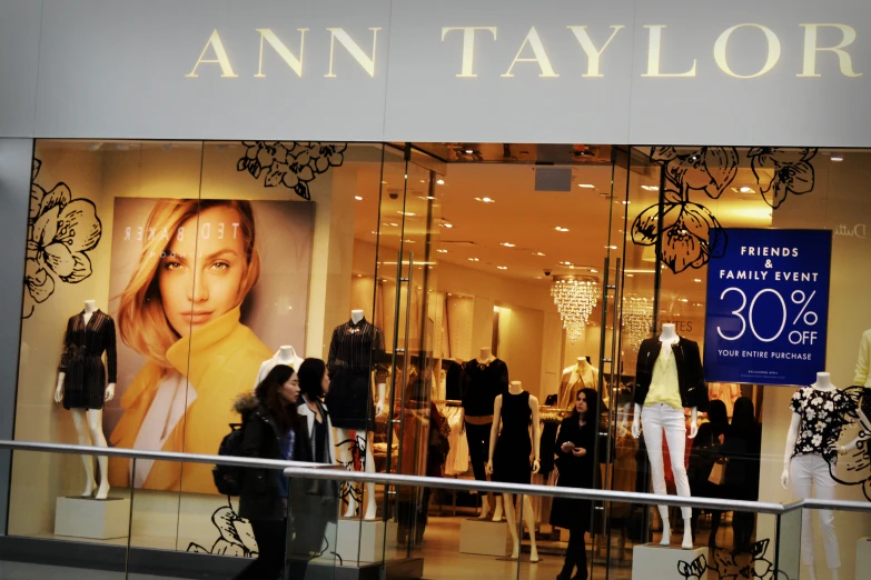 an elegant shopfront with several women's clothing items displayed