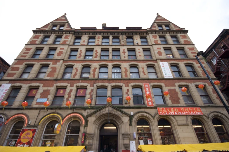 a building with many shops and people walking on the street