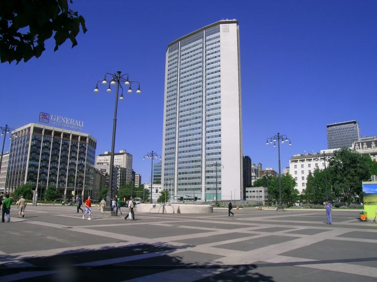a tall white building surrounded by many other buildings
