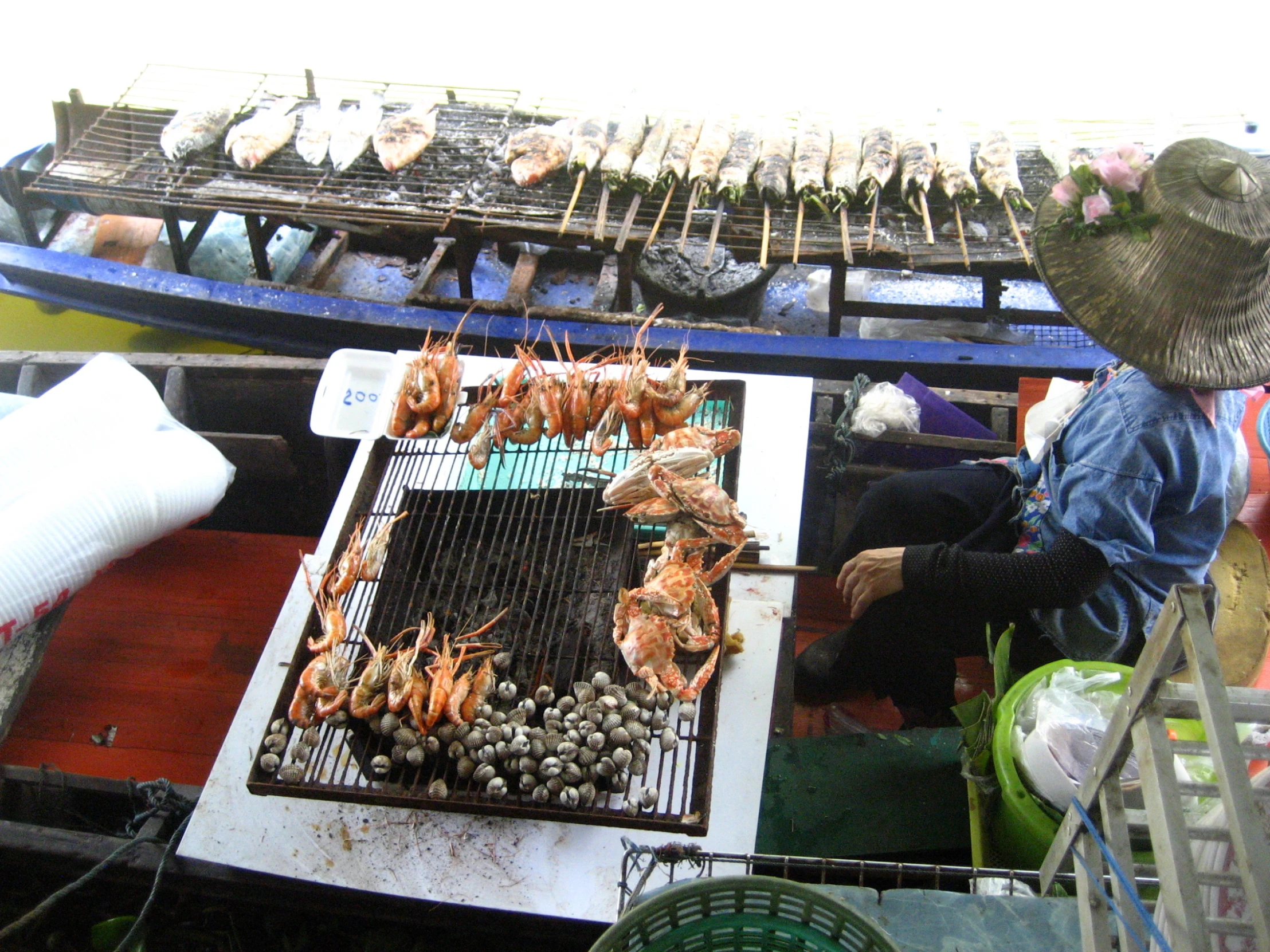 people cooking and grilling many different kinds of food