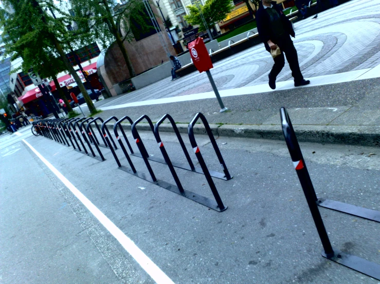 this is a sidewalk with several barriers along side of the road