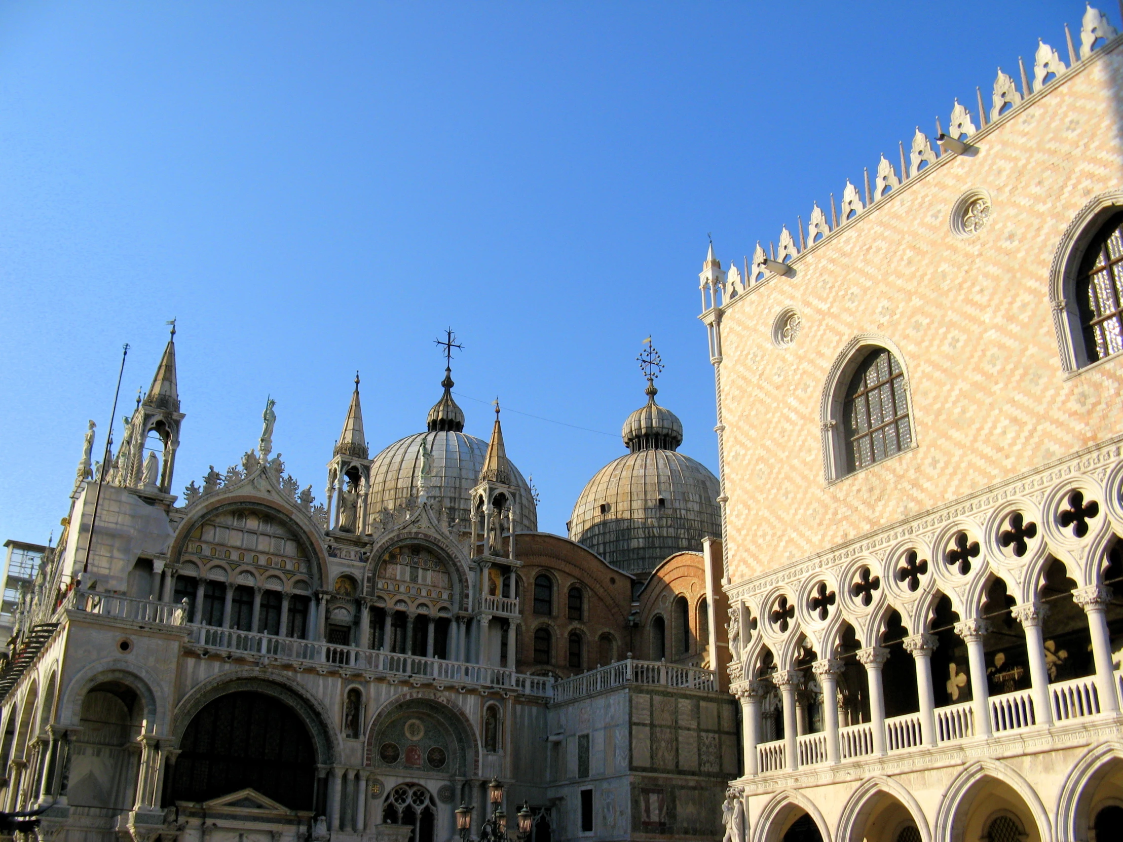 a close up of a large building with ornate arches and dome tops