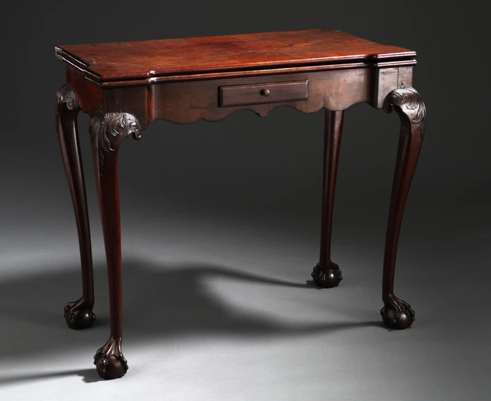 an antique desk with drawers and ornate carvings