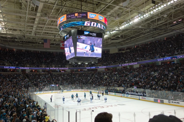 a hockey game in an arena with many people watching