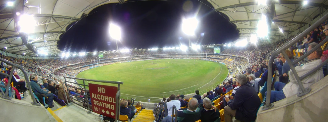 a stadium filled with people standing on top of a field