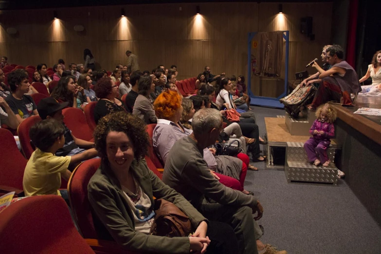 many people are watching a movie in the auditorium