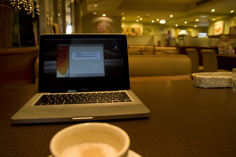 a cup of coffee and a laptop on the table