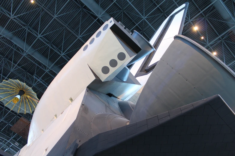 space shuttle is seen on display in a hangar