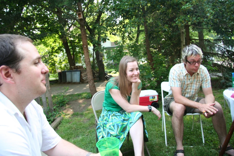 a couple of people sitting around in chairs