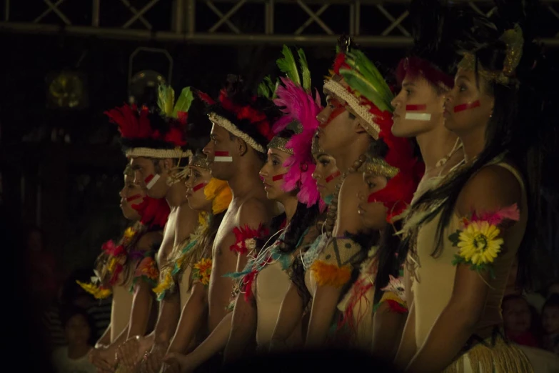 a bunch of women standing up with colorful clothes