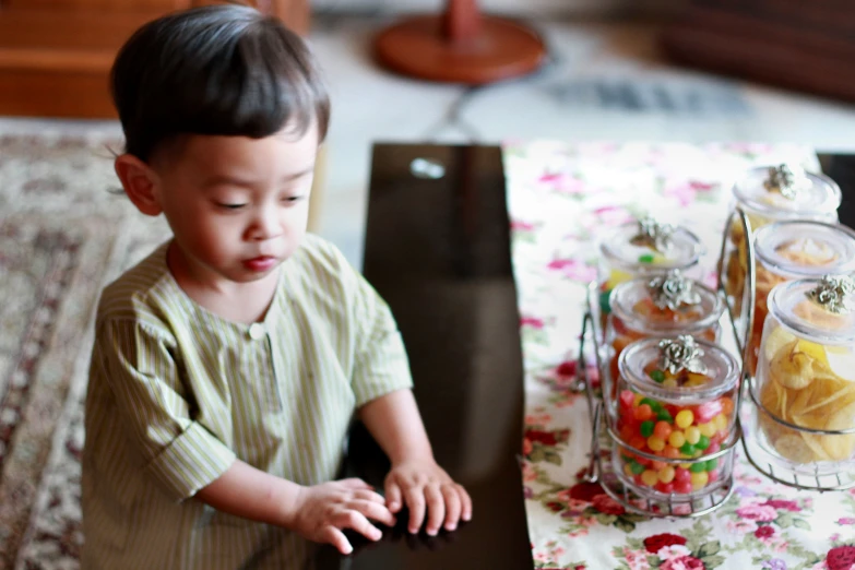 a little boy with his hands in the jar