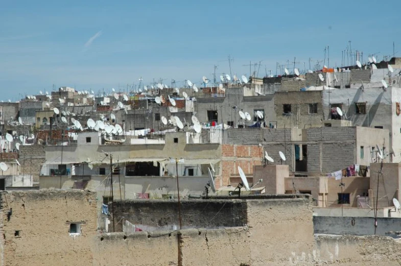 large group of roofs in city with houses and a sky background