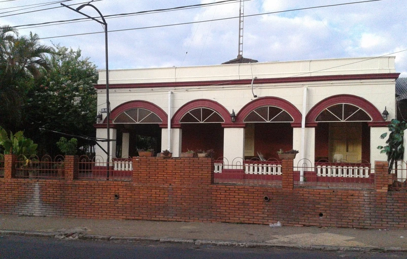 an old building sits on the corner in front of a street