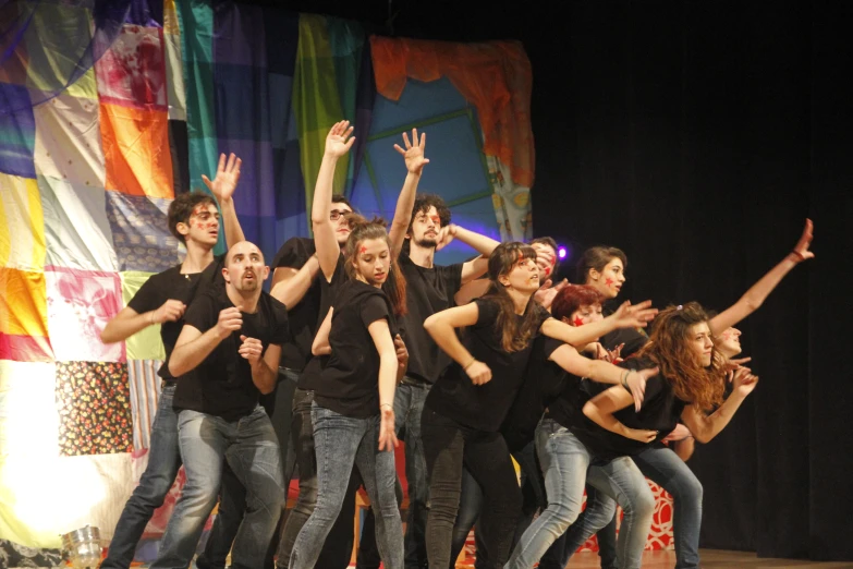 a group of young people standing on top of a stage