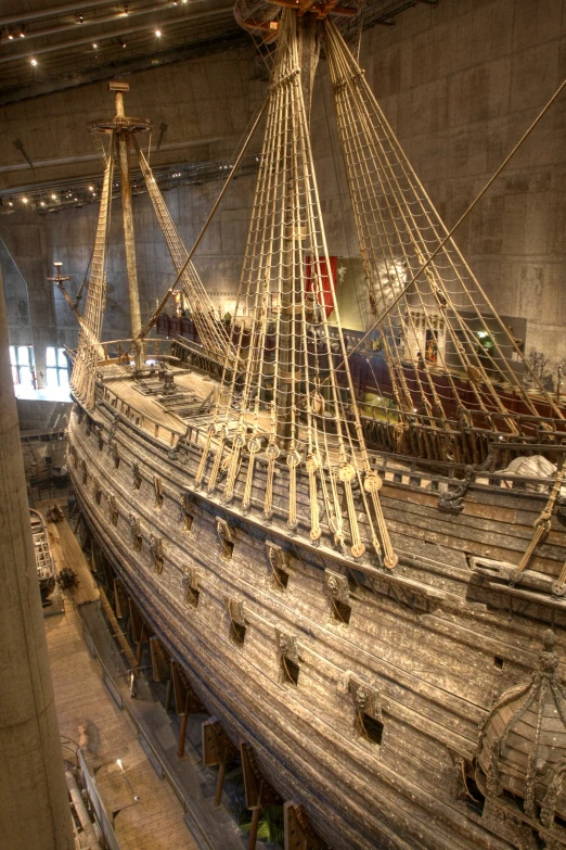 a large boat is sitting on display inside