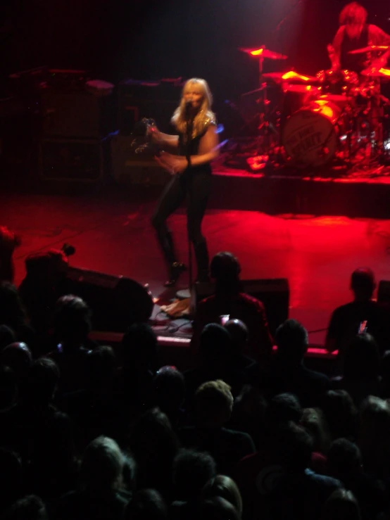 a woman on stage singing into a microphone