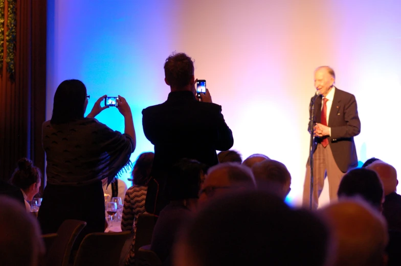 a person in a suit giving a speech