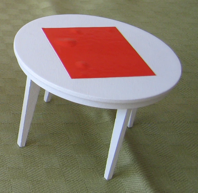 a small white table with a red square on it