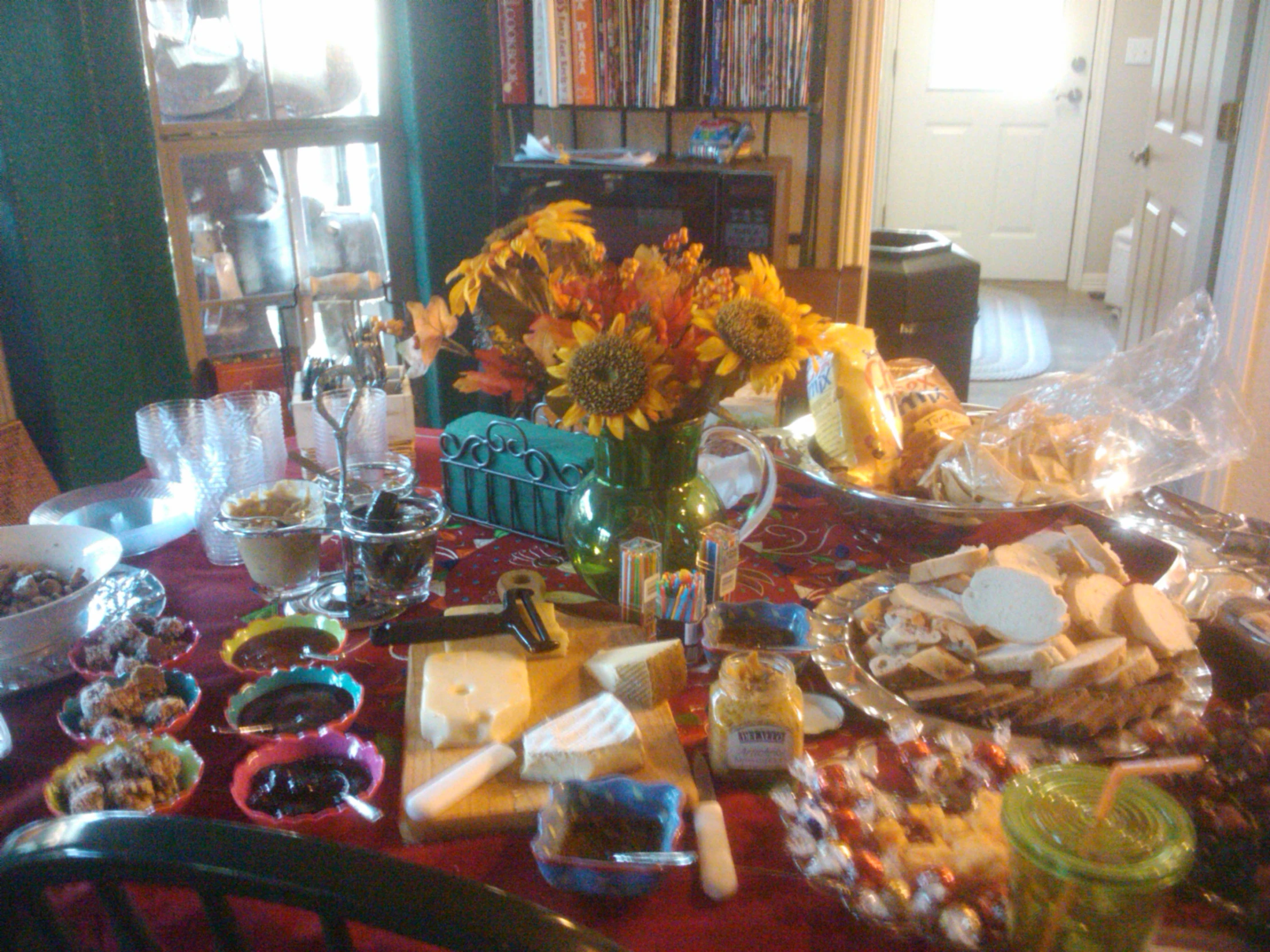 the dining room table is laden with many fancy snacks and candy