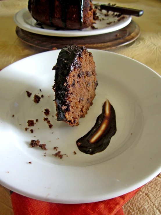 a piece of cake is being cut from the white plate