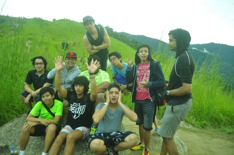 group of young people pose for pograph on a hilltop