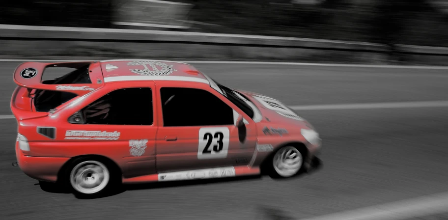 an image of a red race car going by