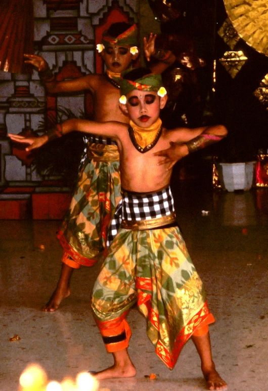 two children are performing a musical during the day