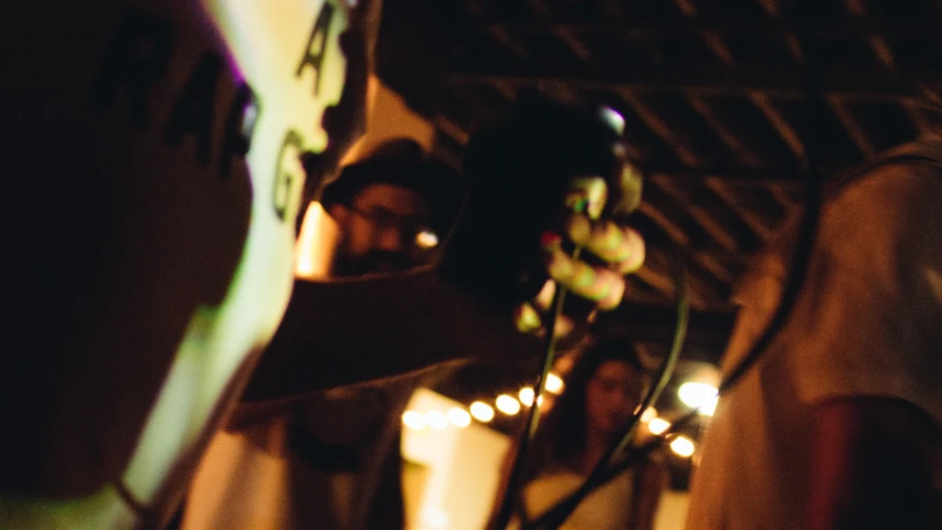 a person holding up an electric guitar in the dark