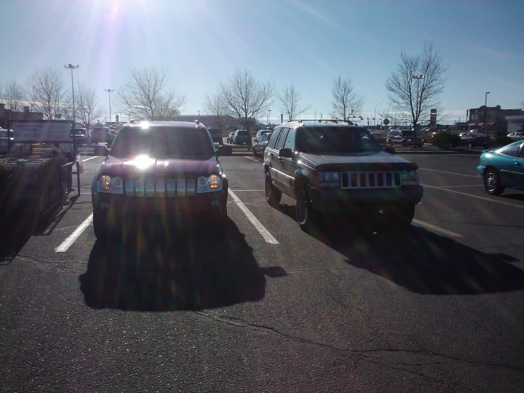 a pair of vehicles parked in an empty parking lot