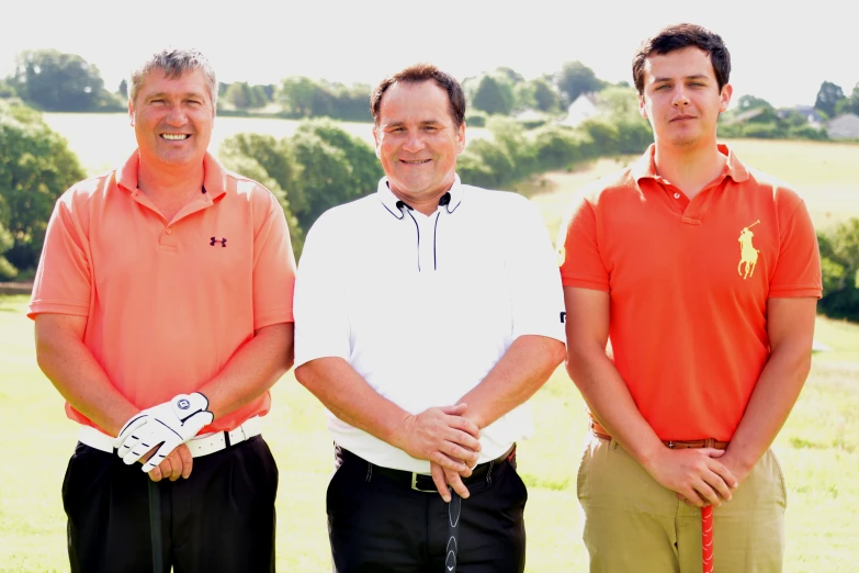 three men stand side by side in front of the camera