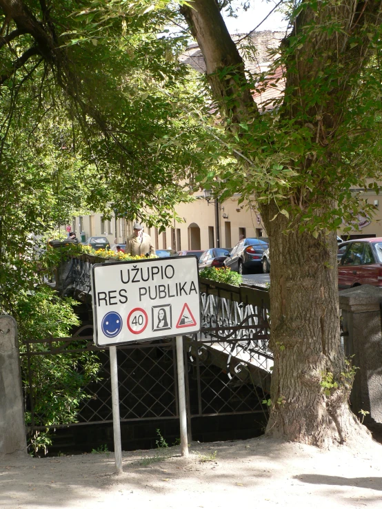 there is a street sign that is posted next to a tree