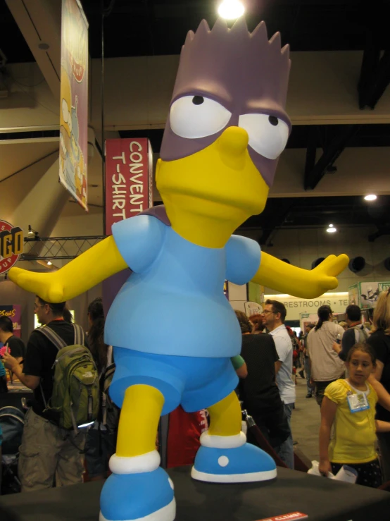 a cartoon character statue sitting in front of a crowd