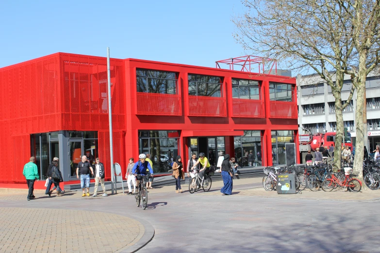a large building with people on bikes outside