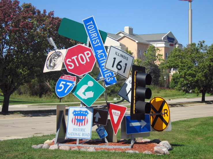 a roadside sculpture of multiple road signs