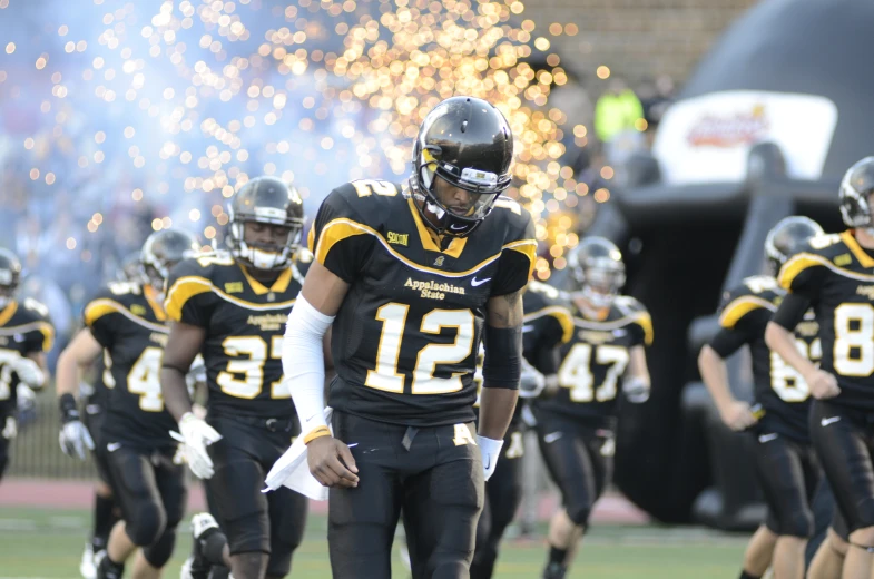 the football team is all dressed in black and yellow