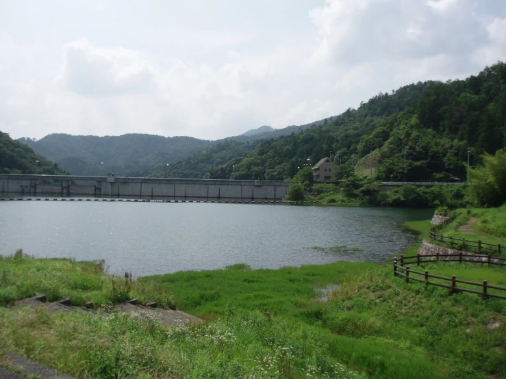 a large lake in front of a train track