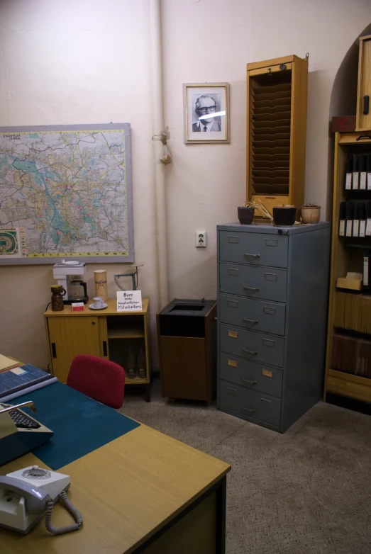 this is a very cluttered office with a very large map