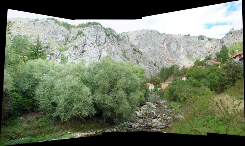 there is a mountain and green trees in the valley