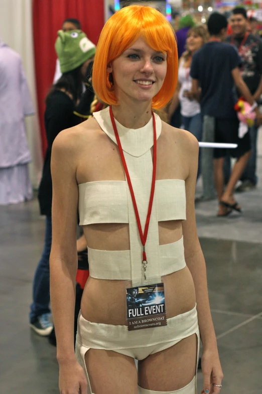 a female with orange hair standing in an area