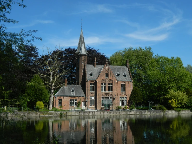 an old brick building with its reflection in the water