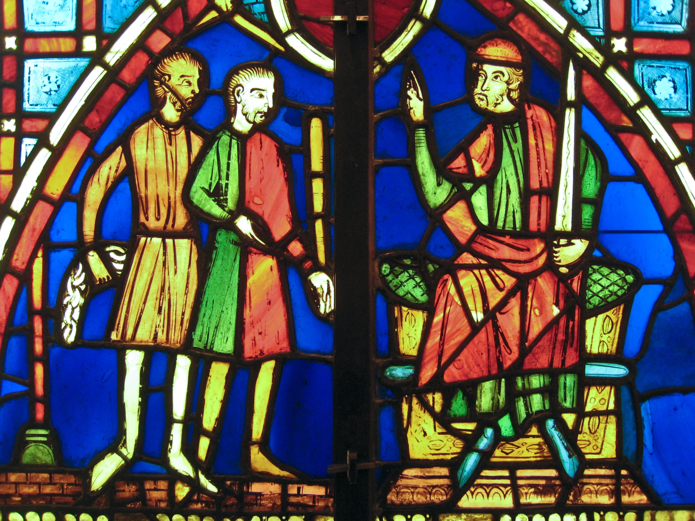 the stained glass in this gothic cathedral shows two men talking