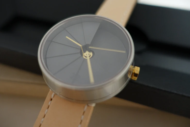 a gold and grey watch with a brown leather strap