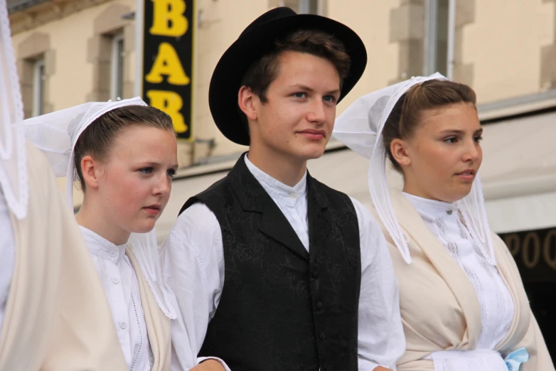 two boys and a girl dressed in traditional clothes